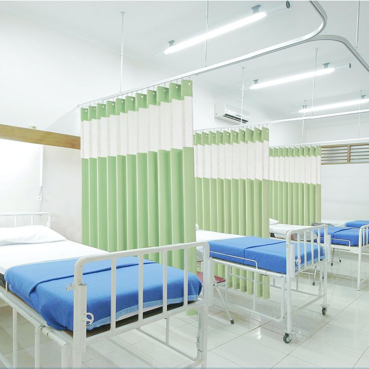 Hospital ward with mesh-top cubicle curtains